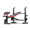 An adjustable weight bench press multi-station fitness equipment with a black and red color scheme, featuring a barbell and weight plates holder.